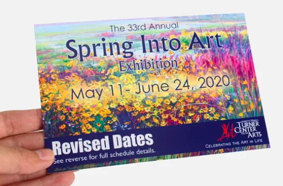 Custom postcard with vibrant floral design and revised dates.